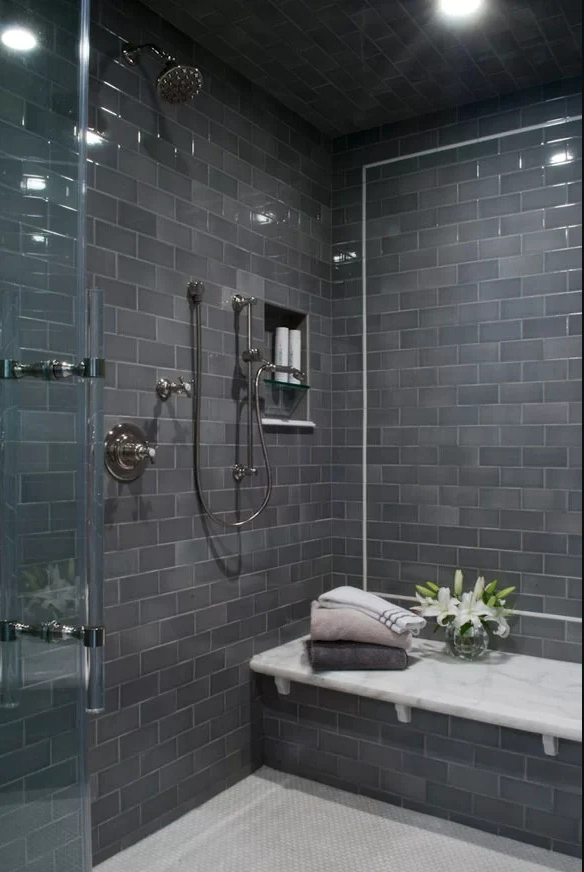 walk in shower with gray tile