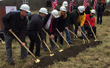 a group of supporters breaks ground at a smart home site. 
